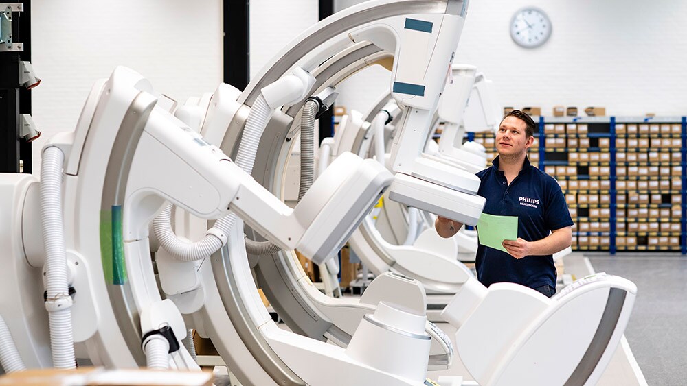 A factory worker overseeing refurbished equipment